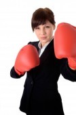 17058551-young-attractive-business-woman-with-boxing-gloves-are-ready-for-battle